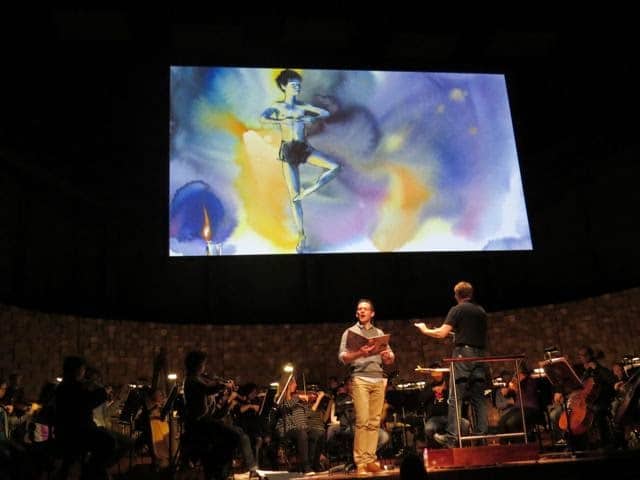 The Peasant Prince in performance with the Tasmanian Symphony Orchestra, illustrations from the book projected above the orchestra